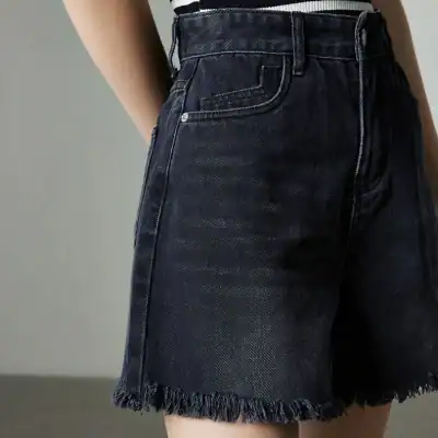 Comfy high-waisted black denim shorts with frayed hem, perfect for summer, casual outings, and fashion-forward looks. Ideal for women seeking trendy denim fashion pieces.