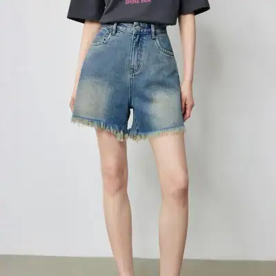 Stylish high-waisted denim shorts with frayed hem, perfect for summer casual wear and outdoor activities. Comfortable fit with trendy design, ideal for everyday fashion.