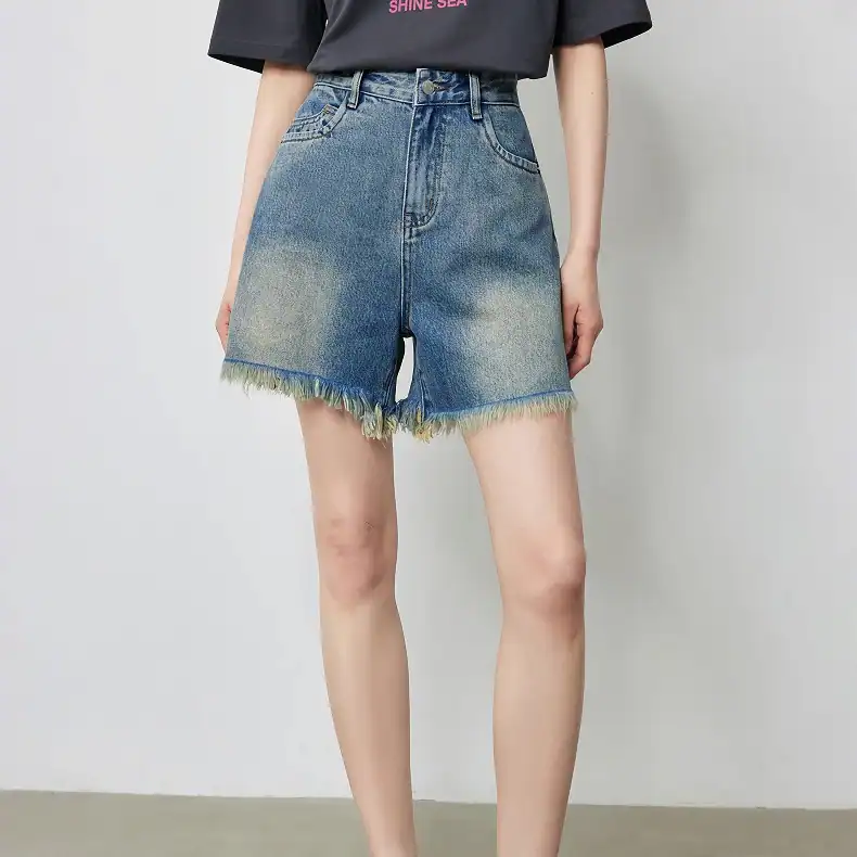 Stylish high-waisted denim shorts with frayed hem, perfect for summer casual wear and outdoor activities. Comfortable fit with trendy design, ideal for everyday fashion.