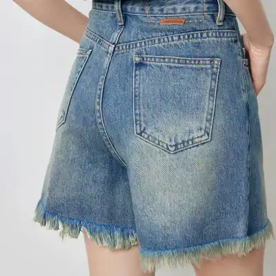 Comfortable blue denim shorts with frayed edges, perfect for casual wear and outdoor activities. High-quality, fashionable, and designed for a comfortable fit around the waist and hips.