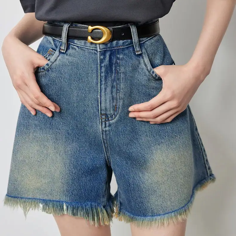 Stylish high-waisted denim shorts with frayed hem, perfect for summer fashion and casual wear. Comfortable fit with trendy distressed details suited for everyday outfits.
