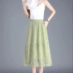 Elegant green patterned maxi skirt for women, perfect for summer outings. Comfortable elastic waistband, stylish design, versatile for casual or dressy occasions.
