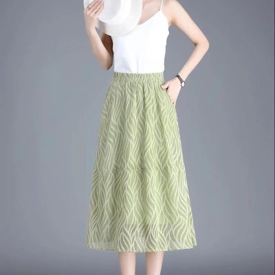 Elegant green patterned maxi skirt for women, perfect for summer outings. Comfortable elastic waistband, stylish design, versatile for casual or dressy occasions.
