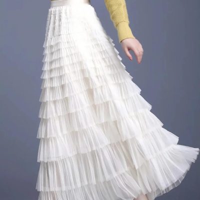 Fashionable white tiered pleated skirt, perfect for stylish women’s clothing and elegant outfits. Ideal for casual wear, parties, or special occasions with trendy and comfortable design.