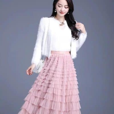 Stylish women's white knitted top with a pink tiered ruffle maxi skirt for diverse occasions. Shop trendy women's clothing at Monalisa Store for fashionable and elegant apparel.