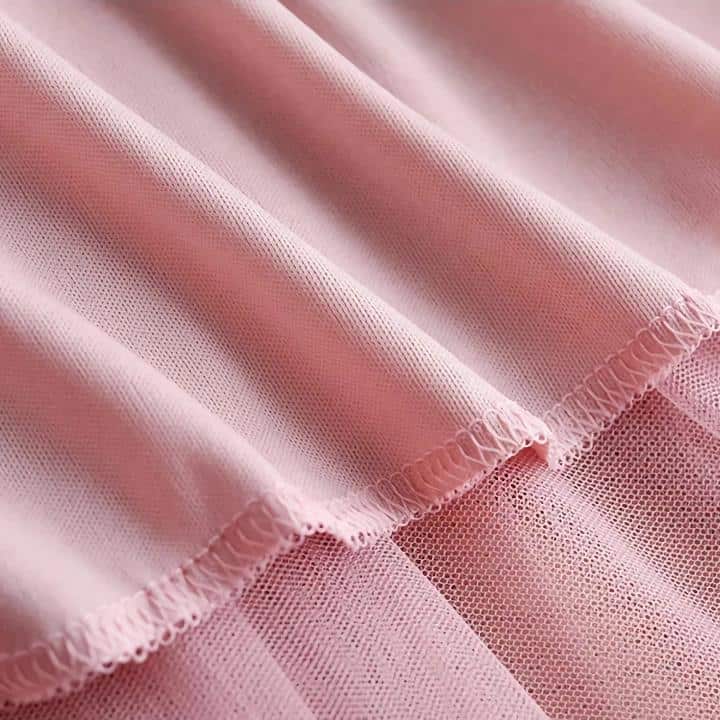 High-quality pink mesh fabric for versatile use in fashion, costumes, and crafts. Lightweight, breathable, and durable material ideal for stylish and comfortable clothing or accessories.