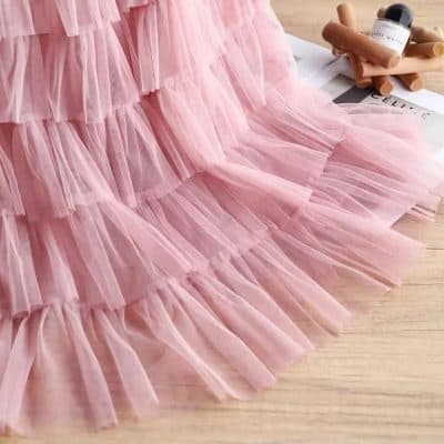 Delicate pink tulle tutu skirt perfect for ballet, dance, or special occasions. Soft, layered design with a charming ruffle trim for a stylish and comfortable fit. Ideal for girls who love dance or costume dress-up.