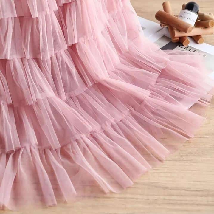 Delicate pink tulle tutu skirt perfect for ballet, dance, or special occasions. Soft, layered design with a charming ruffle trim for a stylish and comfortable fit. Ideal for girls who love dance or costume dress-up.