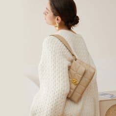 A stylish beige quilted handbag with gold hardware, perfect for fashionable women seeking elegant accessories for everyday use.