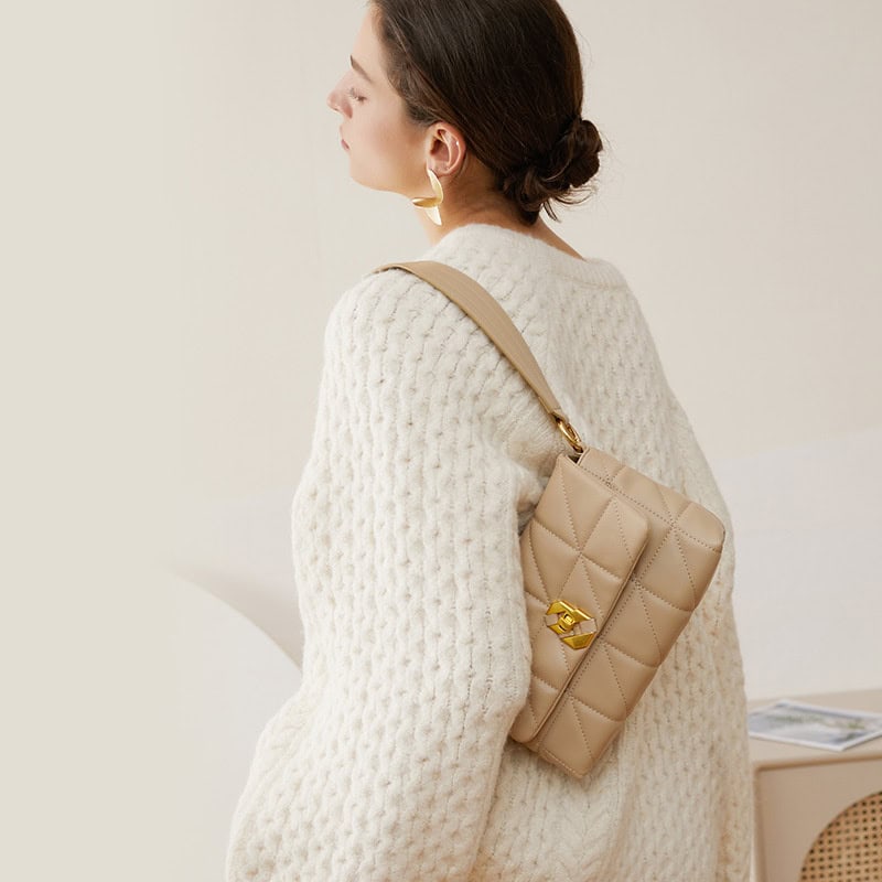 A stylish beige quilted handbag with gold hardware, perfect for fashionable women seeking elegant accessories for everyday use.