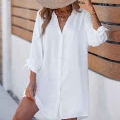 A stylish white dress shirt with button-down front, perfect for summer outings, beach vacations, or casual wear. Made from lightweight, breathable fabric, ideal for a relaxed, chic look.