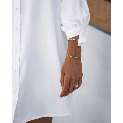 Close-up of woman's hand wearing elegant jewelry, including rings and bracelets, during a visit to Monalisa Store, a top optometry retail destination offering stylish eyewear and accessories.