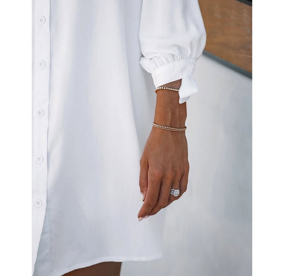 Close-up of woman's hand wearing elegant jewelry, including rings and bracelets, during a visit to Monalisa Store, a top optometry retail destination offering stylish eyewear and accessories.