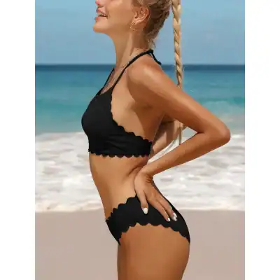 Stylish black bikini set for women featuring scalloped edges, perfect for beach outings and swimming pools. Comfortable and trendy swimwear designed for a flattering fit and sunbathing.