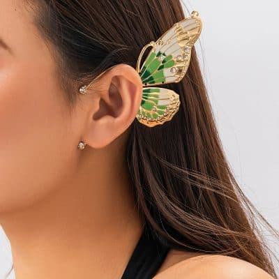 Elegant butterfly-shaped hair clip with gold detailing, green accents, and sparkling rhinestones for stylish hair decoration and fashion.