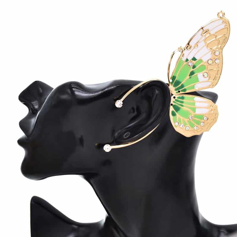 Stylish butterfly-shaped gold ear cuff with green and white enamel accents and sparkling crystals for a chic, modern jewelry statement.