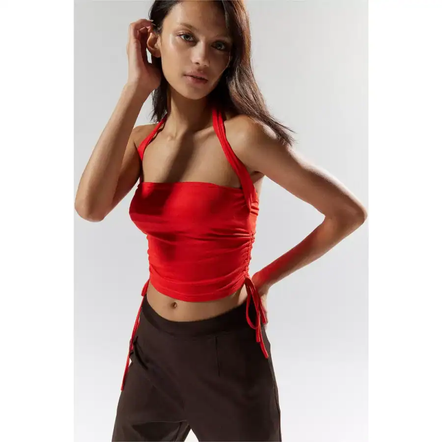 Stylish red crop top with adjustable side ties, perfect for trendy looks and summer wear. Crafted for comfort and elegance, ideal for casual outings or fashionable events.