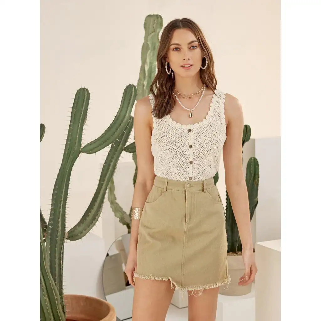 Stylish cotton sleeveless top paired with a distressed hem skirt, perfect for trendy casual wear.