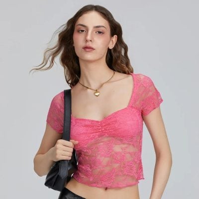 Elegant pink lace crop top with floral pattern, short sleeves, and flattering fit, perfect for fashion-forward women.