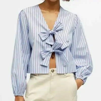 Elegant blue and white striped blouse with front bow ties, perfect for stylish casual wear or office outfits. Comfortable lightweight fabric with long puff sleeves.