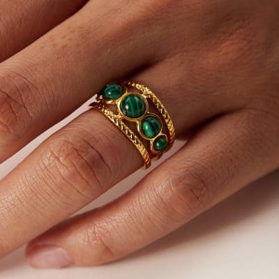 Close-up of a stunning gold ring featuring green malachite stones, perfect for women's jewelry collection and stylish accessories.