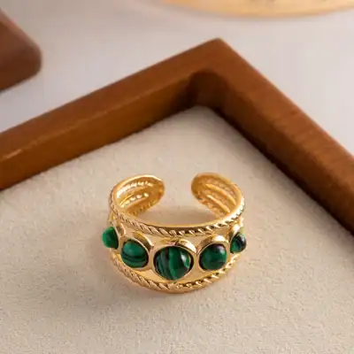 Luxurious gold ring featuring polished malachite stones, perfect for stylish jewelry collection and proper gift options.