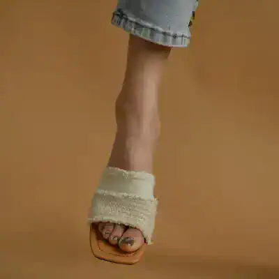 Fashionable women's sandal with trendy ankle wrap, perfect for summer style.