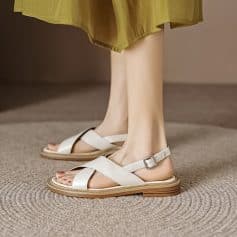 Elegant white women's sandals with ankle strap and cushioned sole, perfect for comfortable everyday wear and stylish casual look.