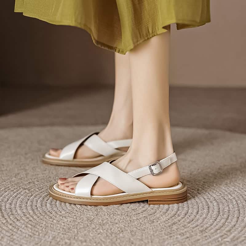 Elegant white women's sandals with ankle strap and cushioned sole, perfect for comfortable everyday wear and stylish casual look.