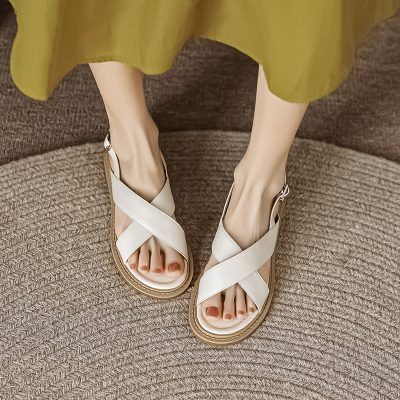 Stylish white sandals with crisscross straps, perfect for casual and summer wear, available at Monalisa Medical Store.