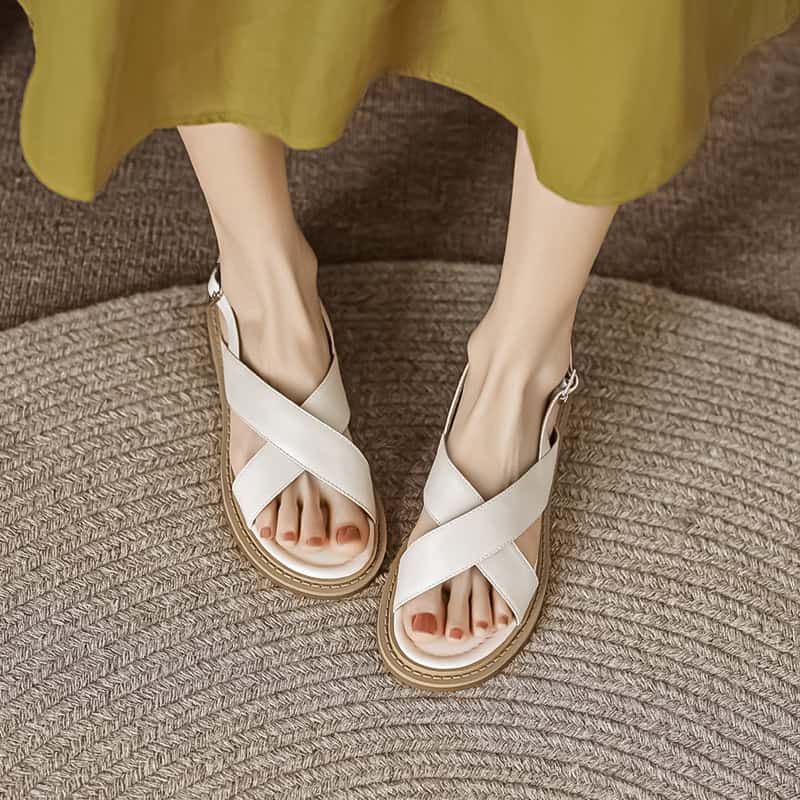Stylish white sandals with crisscross straps, perfect for casual and summer wear, available at Monalisa Medical Store.