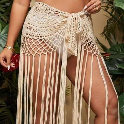 Beautiful handcrafted crochet beach cover-up with intricate open-knit design, perfect for stylish beach or poolside wear. Crafted with premium materials for comfort and durability in tropical environments.