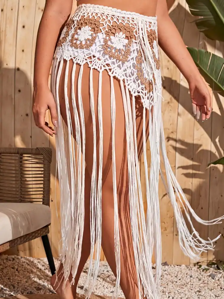 Elegant crochet bohemian skirt with fringe design, perfect for beachwear and summer fashion. Made with lightweight material, offering a stylish and comfortable look for women.