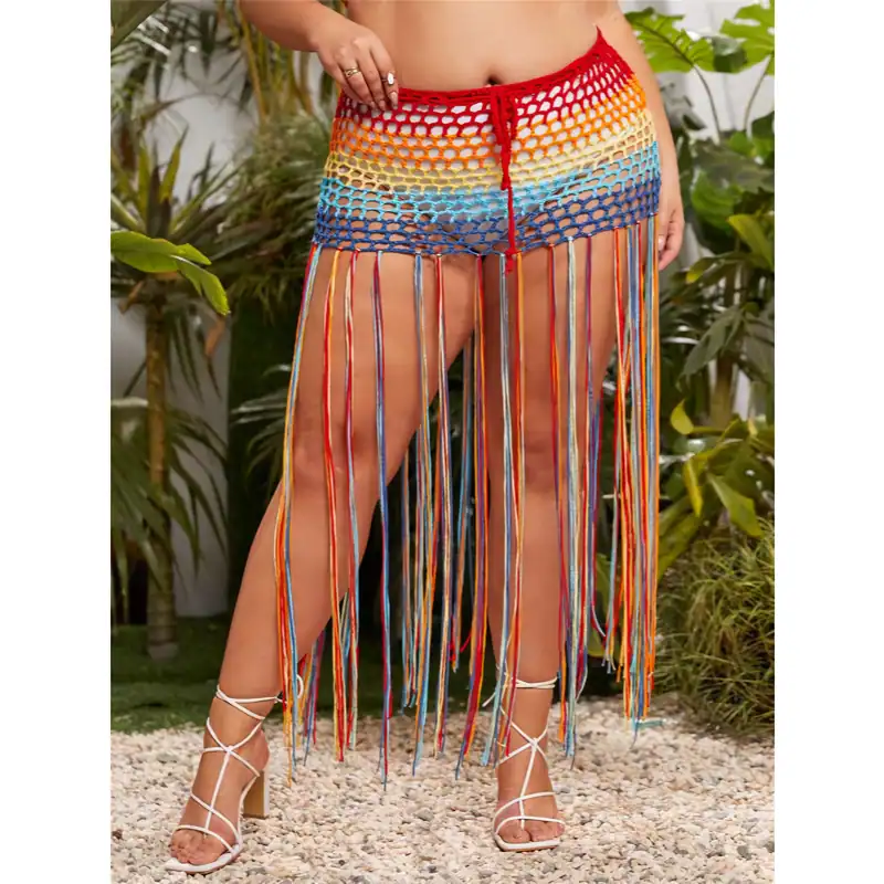 Colorful crochet beach cover-up with long rainbow-colored fringe, ideal for summer and beachwear. Stylish and breathable, perfect for vacation or poolside fashion.