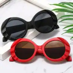 Stylish round sunglasses with black and red frames, perfect for UV protection and fashion statements. Ideal for sunny days, available at Monalisa Store for trendy eyewear.