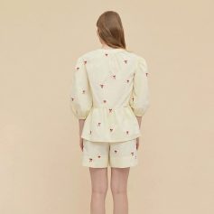 Comfortable cream-colored loungewear with red bow embroidery, perfect for relaxing and sleepwear.