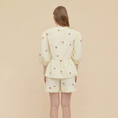 Comfortable cream-colored loungewear with red bow embroidery, perfect for relaxing and sleepwear.