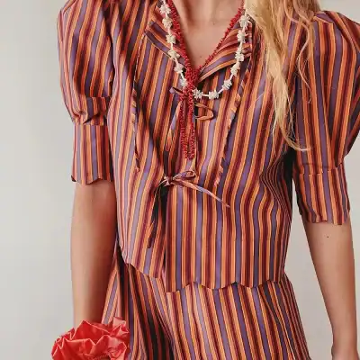 Colorful striped blouse with a front tie, perfect for summer fashion, casual wear, and trendy style. Made with comfortable fabric, ideal for a stylish look.