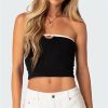 Girl wearing fashionable black crop top with white trim, perfect for summer or casual outings.