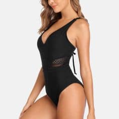 Stylish black crochet swimsuit with cutout details, perfect for beach wear and poolside lounging. Comfortable, trendy, and ideal for summer vacation essentials.