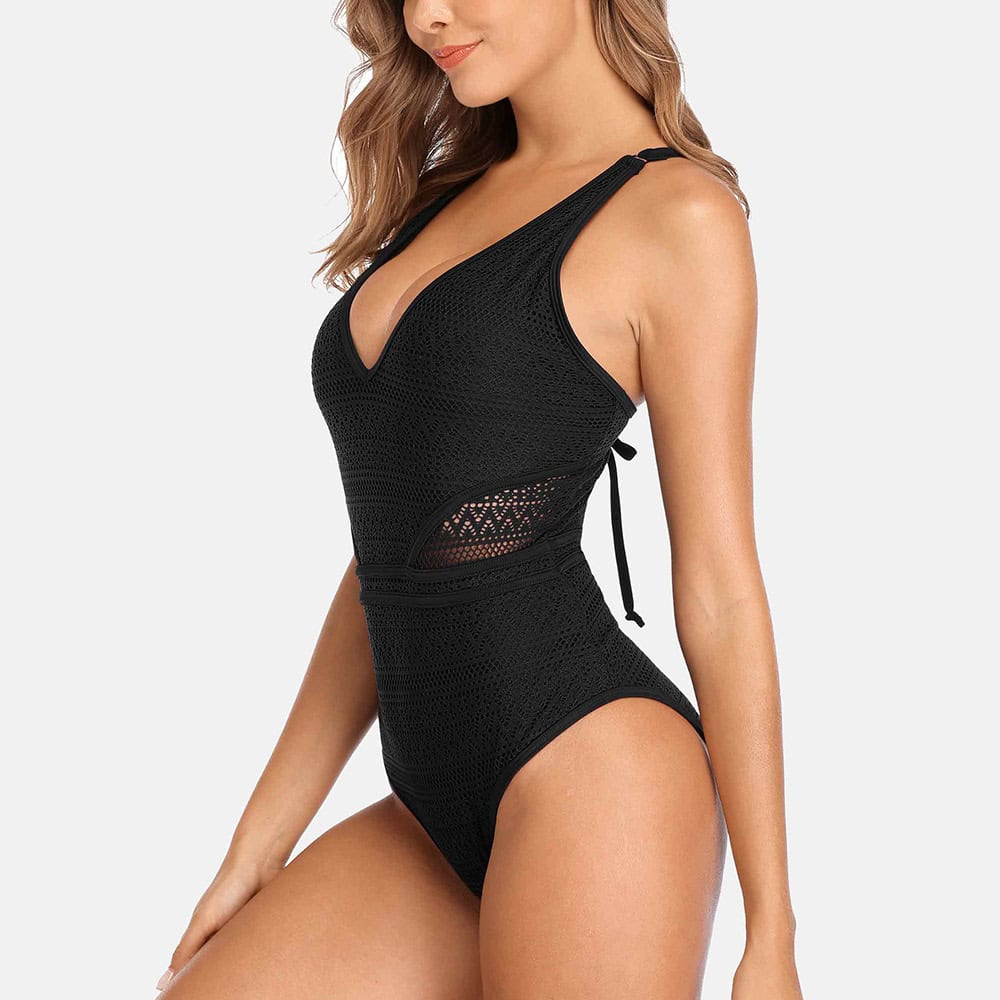 Stylish black crochet swimsuit with cutout details, perfect for beach wear and poolside lounging. Comfortable, trendy, and ideal for summer vacation essentials.