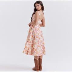 Fashionable floral dress ideal for summer outfits, paired with trendy cowboy boots, perfect for a chic and comfortable look.
