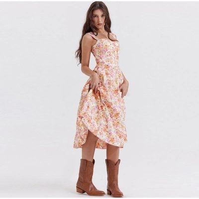 A woman modeling a floral midi dress with ruffle straps and side slit, highlighting summer fashion, casual style, and feminine clothing. Perfect for stylish, comfortable summer wear and outdoor events.