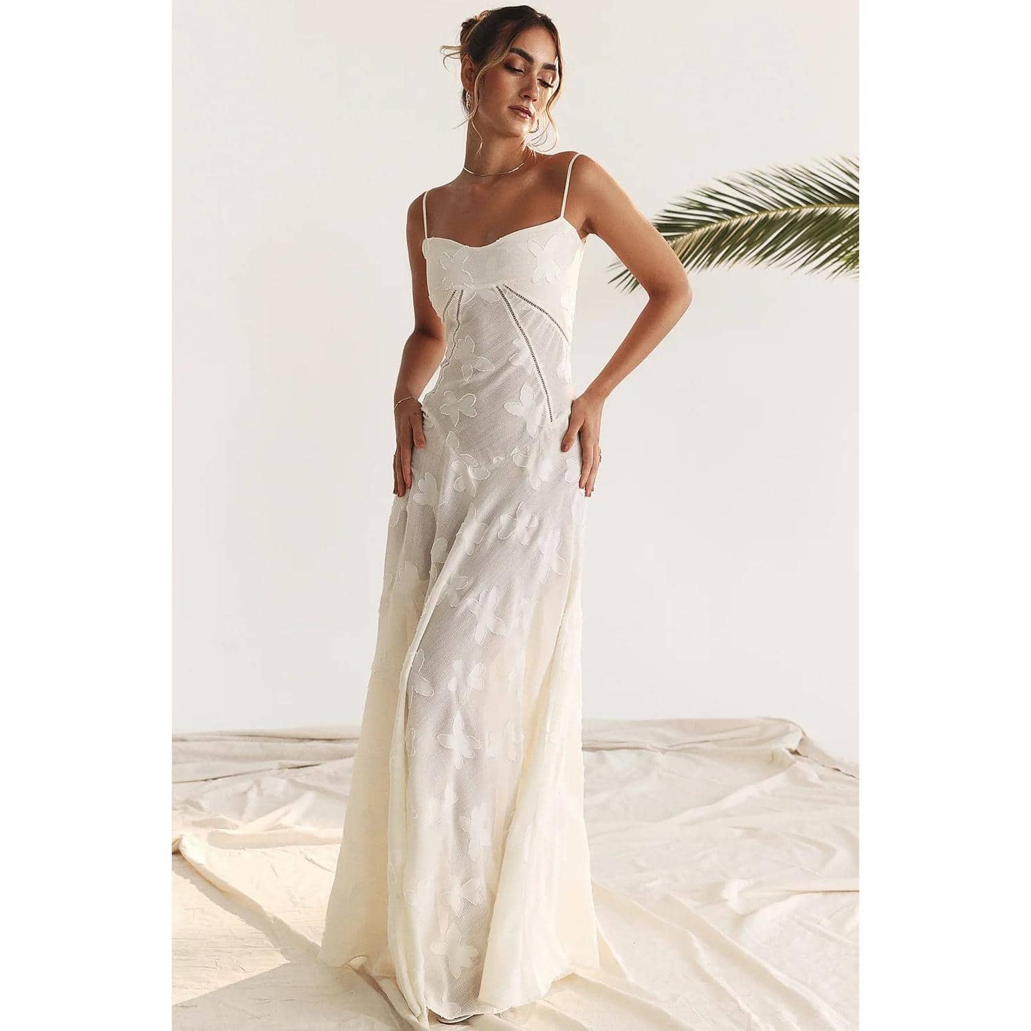 Chic white butterfly print dress with delicate spaghetti straps, flowy silhouette, and sophisticated design. Ideal for summer outings, casual gatherings, or stylish daytime wear. Comfortable and stylish.