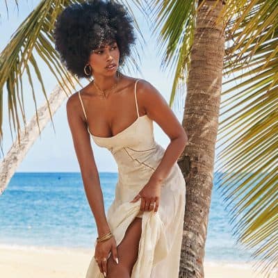 Elegant summer dress, beach fashion, and accessories for women at Monalisa Store on the beach.