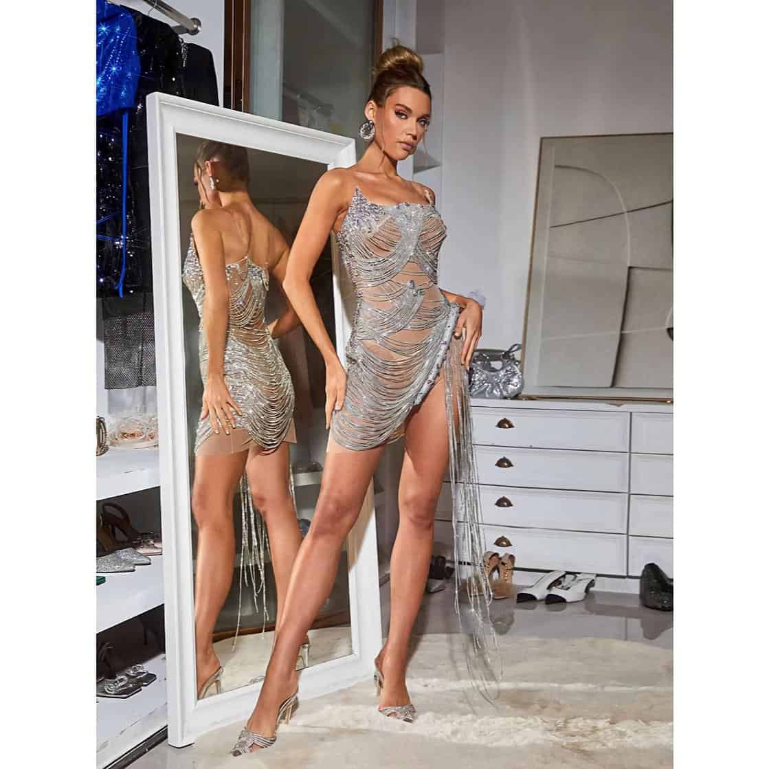Elegant silver sequin evening gown with intricate detailing and a high slit for a glamorous look. Perfect for special events, galas, or parties, showcasing style and sophistication.