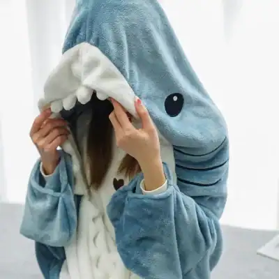 A playful and cozy shark-themed hoodie featuring a fun shark face design and soft plush fabric, perfect for children’s comfort and style.