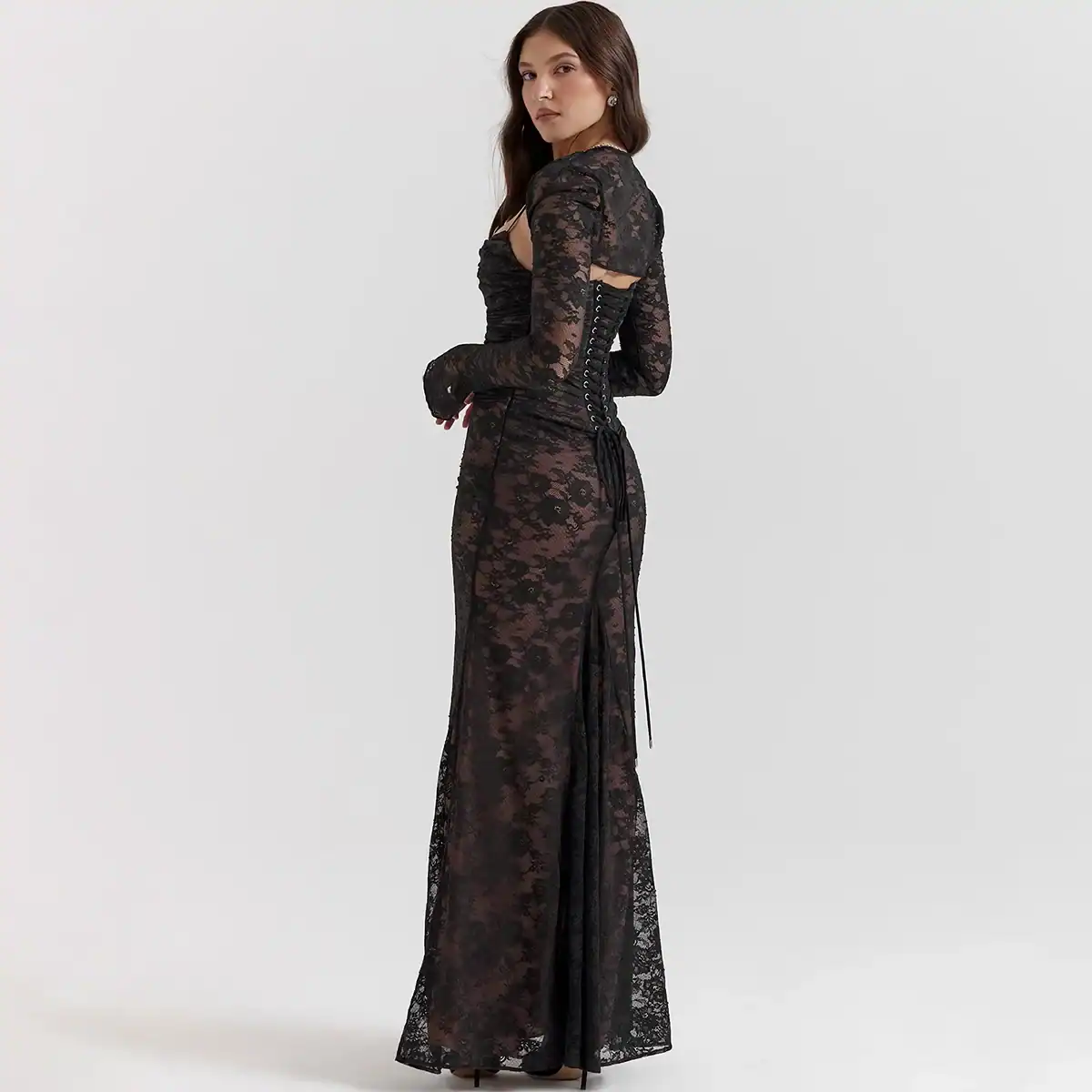 A stunning black lace gown featuring intricate floral lace design, side lace-up detail, and long sleeves, ideal for formal events and stylish outings.