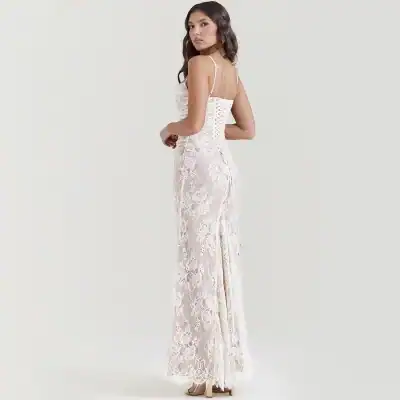 Luxurious white lace maxi dress with a fitted bodice, spaghetti straps, and intricate floral lace details, perfect for formal occasions or weddings.