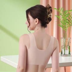 Close-up of a woman wearing a beige backless top, showing stylish shoulder design and smooth skin, perfect for summer fashion and casual wear.